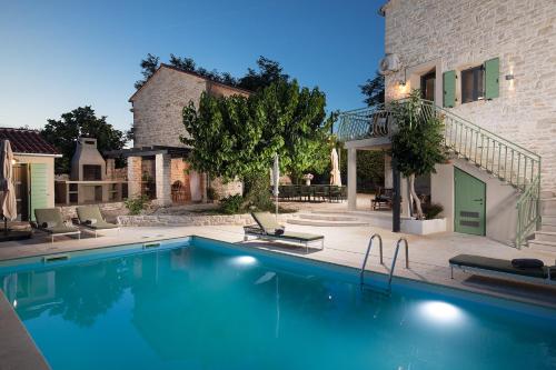 a swimming pool in front of a building at Villa Stanza Campitelli for up to 21 people in Central Istria with private pool and pet friendly in Bale