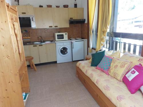 un salon avec un canapé et une cuisine dans l'établissement Les Appartements Diochon, à Le Baplieu