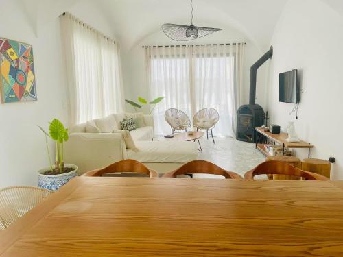 a living room with a wooden table and chairs at Villa Jedidi in Hammamet Sud
