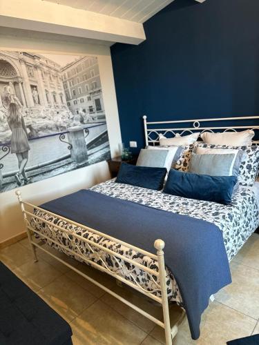 a bed in a room with a painting on the wall at Agriturismo il maniero in Ancona