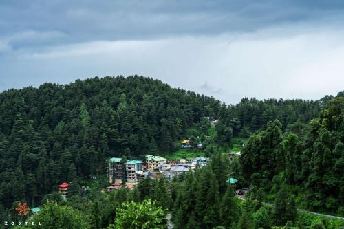 a town in the middle of a mountain at Zostel Dharamkot in McLeod Ganj