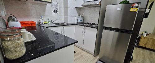 a kitchen with a stainless steel refrigerator at The Hideout in Suva