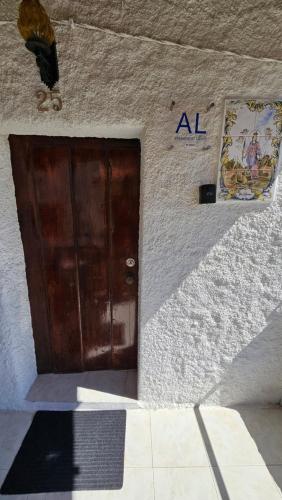 a door to a building with a al sign on it at Casa da Catraia - Remodelação recente nos quartos in Póvoa de Midões