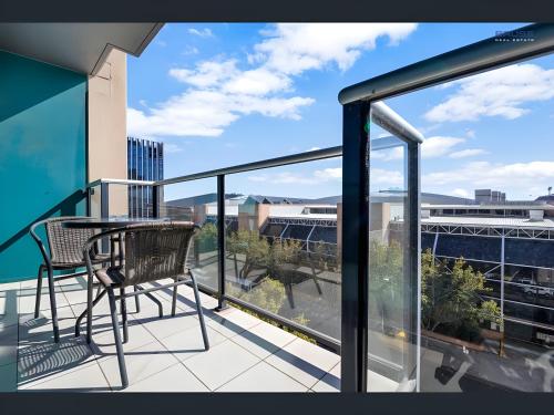 a balcony with a table and chairs on a building at Swainson at Horizons in Adelaide