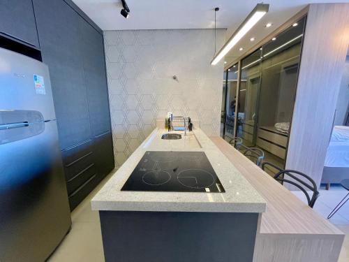 a kitchen with a stove and a counter top at A Melhor Vista com Academia no Rooftop in Campo Grande