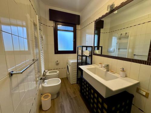 a bathroom with a sink and a toilet and a mirror at Venezia-Mestre Luxury Apartment Bros3 in Mestre