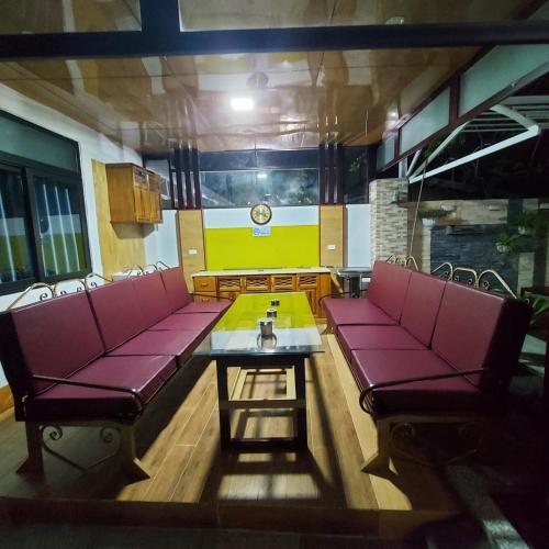 a room with red chairs and a table in a room at QV Manor Homestay in Phan Rang