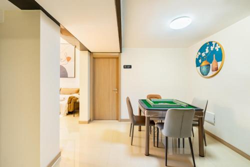 a dining room with a table and chairs at Guangzhou He She Art Apartment in Guangzhou