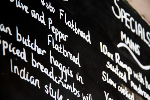 a blackboard with white text on it at Lamlash Bay Hotel in Lamlash
