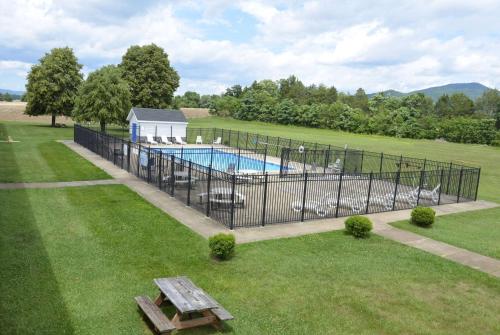 a fence around a swimming pool in a yard at Days Inn by Wyndham Luray Shenandoah in Luray