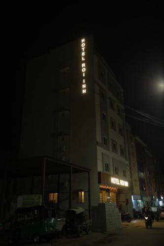 a hotel building with a sign on it at night at Hotel Roi Inn in Tirupati