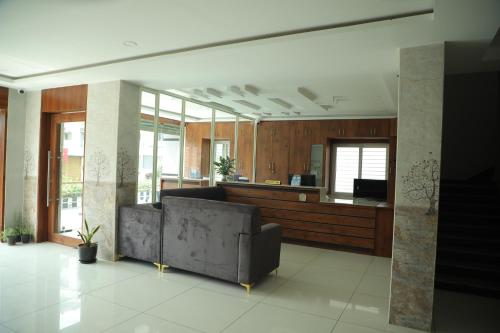 a living room with a couch and a counter at Hotel Roi Inn in Tirupati