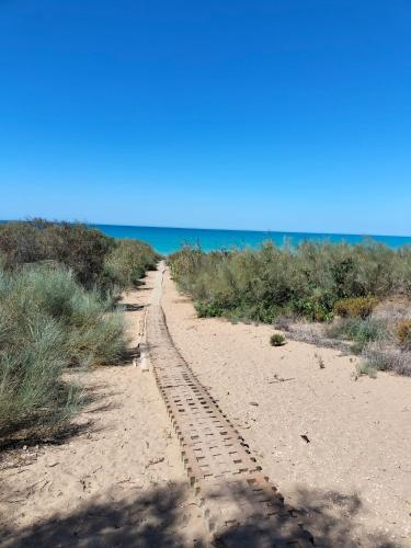 a dirt road leading to the ocean on a beach at A Casa Mia in Butera
