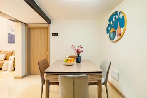 a dining room with a table and chairs at Guangzhou He She Art Apartment in Guangzhou