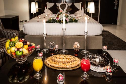 a table with a tray of food and a bed at Aswar Al olaya for serviced Apartments in Al Khobar