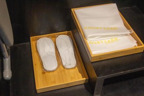 a pair of white shoes in a wooden box at Courtyard by Marriott Melaka in Melaka