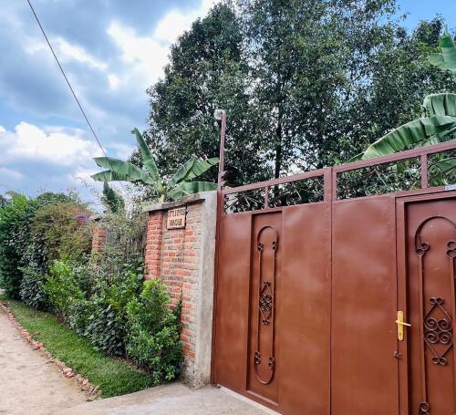 a wooden gate with a fence on top of it at Little Birds Paradise in Ruhengeri