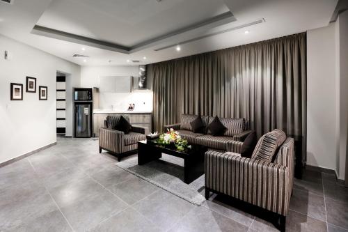 a living room with two couches and a table at Aswar Al olaya for serviced Apartments in Al Khobar