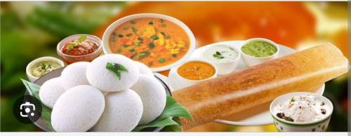 a plate of food with eggs and soup and a bread at Grand Residency in Bengaluru