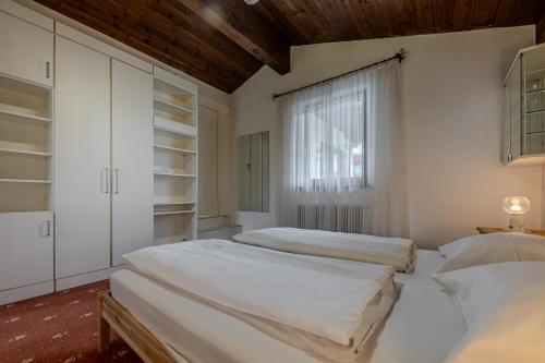 Postel nebo postele na pokoji v ubytování Hahnenkamm Residenz