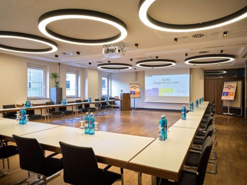 a conference room with tables with blue fire hydrants at Flemings Selection Hotel Frankfurt-City in Frankfurt/Main