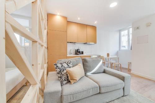 a living room with a couch and a kitchen at By the River - Alcantara Apartments in Lisbon