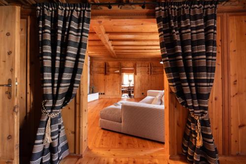 a living room with black and white curtains at Hotel Chesa Rosatsch - Home of Food in Celerina