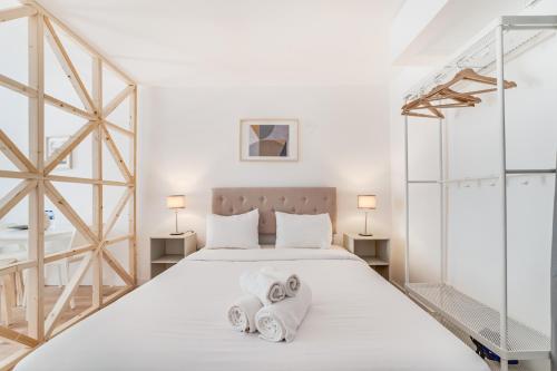 a bedroom with a bed with towels on it at By the River - Alcantara Apartments in Lisbon