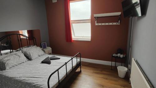 a bedroom with a bed and a window at Xtasia Adult Hotel - Adults Only in West Bromwich