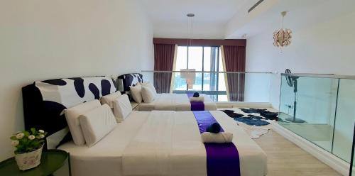 a large bedroom with two beds and a window at M city Ampang Lake view in Kuala Lumpur