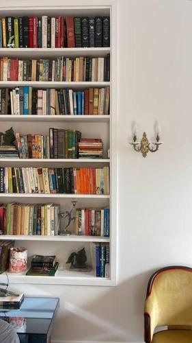 a book shelf filled with lots of books at Captains Rest St Kilda West in Melbourne