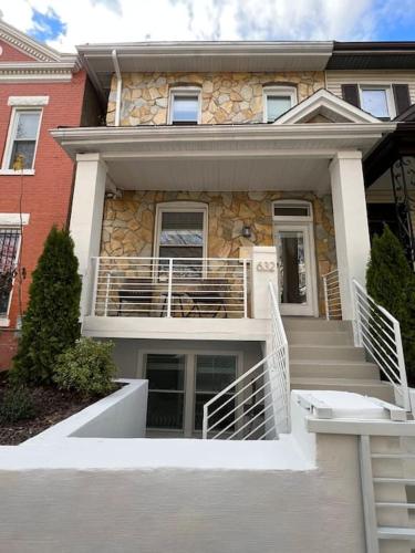 a house with stairs in front of a building at Modern 4BR Columbia Heights Gem Walk 2 Metro & Shops in Washington, D.C.