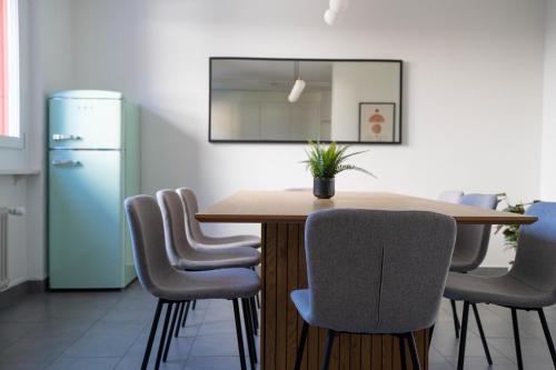 a dining room with a table and chairs and a refrigerator at NH 2 Interlaken-Luzern Lake I Mountain I unique I connect in Sachseln