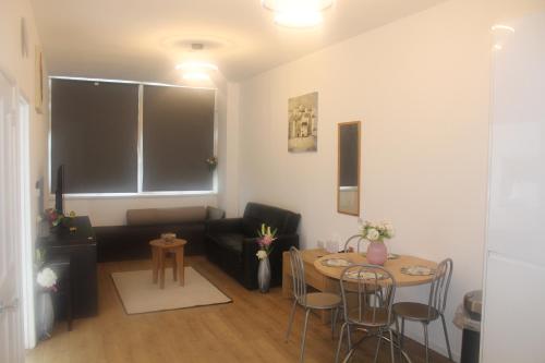 a living room with a couch and a table at Flat 420 One bedroom apartment in Birmingham