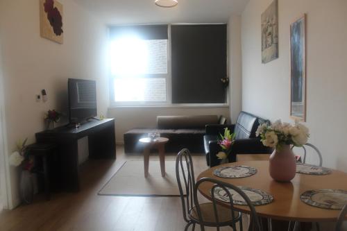 a living room with a table and a couch at Flat 420 One bedroom apartment in Birmingham