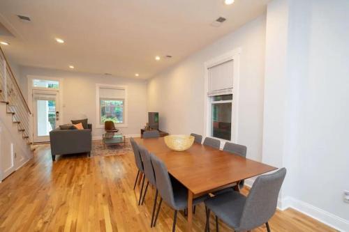 a dining room with a wooden table and chairs at Modern 4BR Columbia Heights Gem Walk 2 Metro & Shops in Washington, D.C.