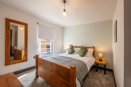 a bedroom with a large bed with a window at Exceptional 2BD Apt - next to ferry & train station in Oban