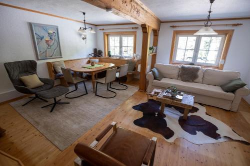 a living room with a couch and a table at Frein Chalets - Kaltenbach in Frein