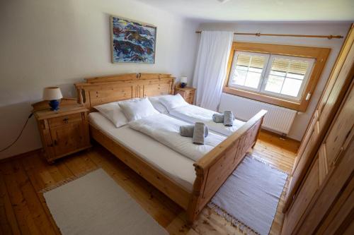 a bedroom with a large bed and a window at Frein Chalets - Kaltenbach in Frein