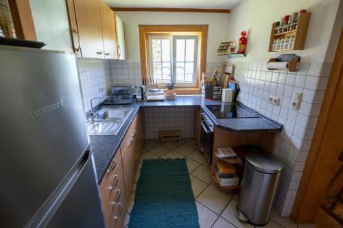 a small kitchen with a sink and a refrigerator at Frein Chalets - Kaltenbach in Frein