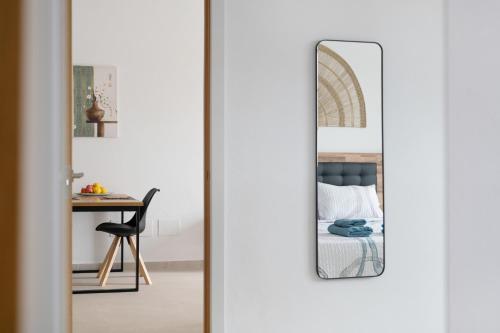 a bedroom with a mirror next to a bed at Casita Lanzarote in Teguise