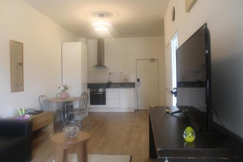 a living room with a couch and a table at Flat 420 One bedroom apartment in Birmingham