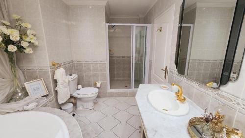 a bathroom with a sink and a toilet and a shower at Boulevard 501 in Margate