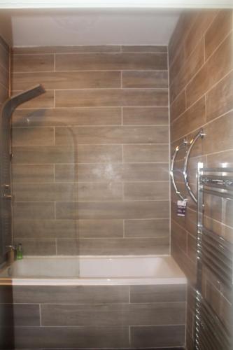 a bathroom with a bath tub and a shower at Flat 420 One bedroom apartment in Birmingham