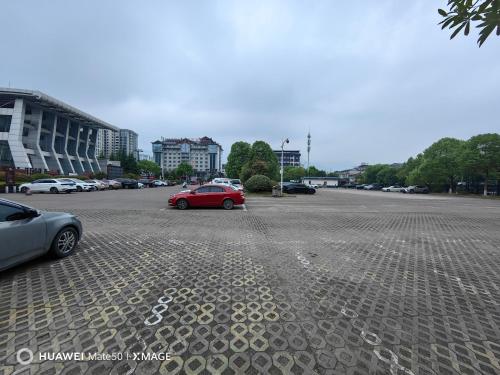 a red car parked in a parking lot at Just waiting for you-Tianmen mountαin-English reception-Book ticket service in Zhangjiajie