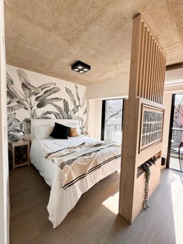 a bedroom with a large bed and a large window at Anywhere Palermo Soho in Buenos Aires