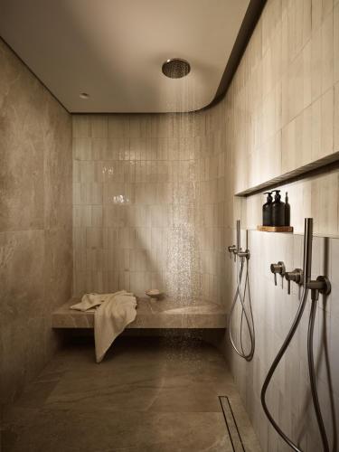 a bathroom with a shower and a bath tub at Mayamor Villas, sea view to Tsilivi beach in Tsilivi