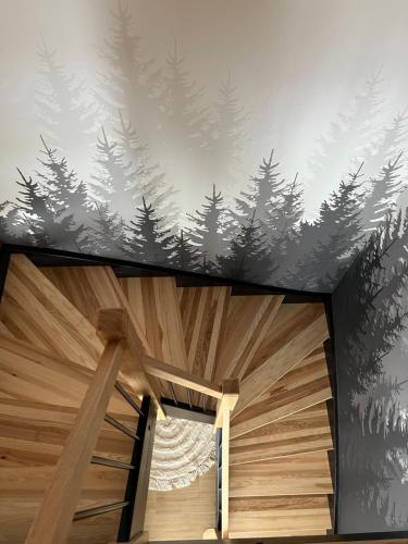 a room with a mural of trees on the wall at Ciwersówka Domki Białka Tatrzańska in Białka Tatrzanska
