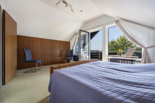 a bedroom with a bed and a large window at Ferienwohnung Hurlebusch Hahnenklee in Goslar