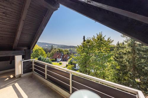 a balcony with a view of a house at Ferienwohnung Hurlebusch Hahnenklee in Goslar